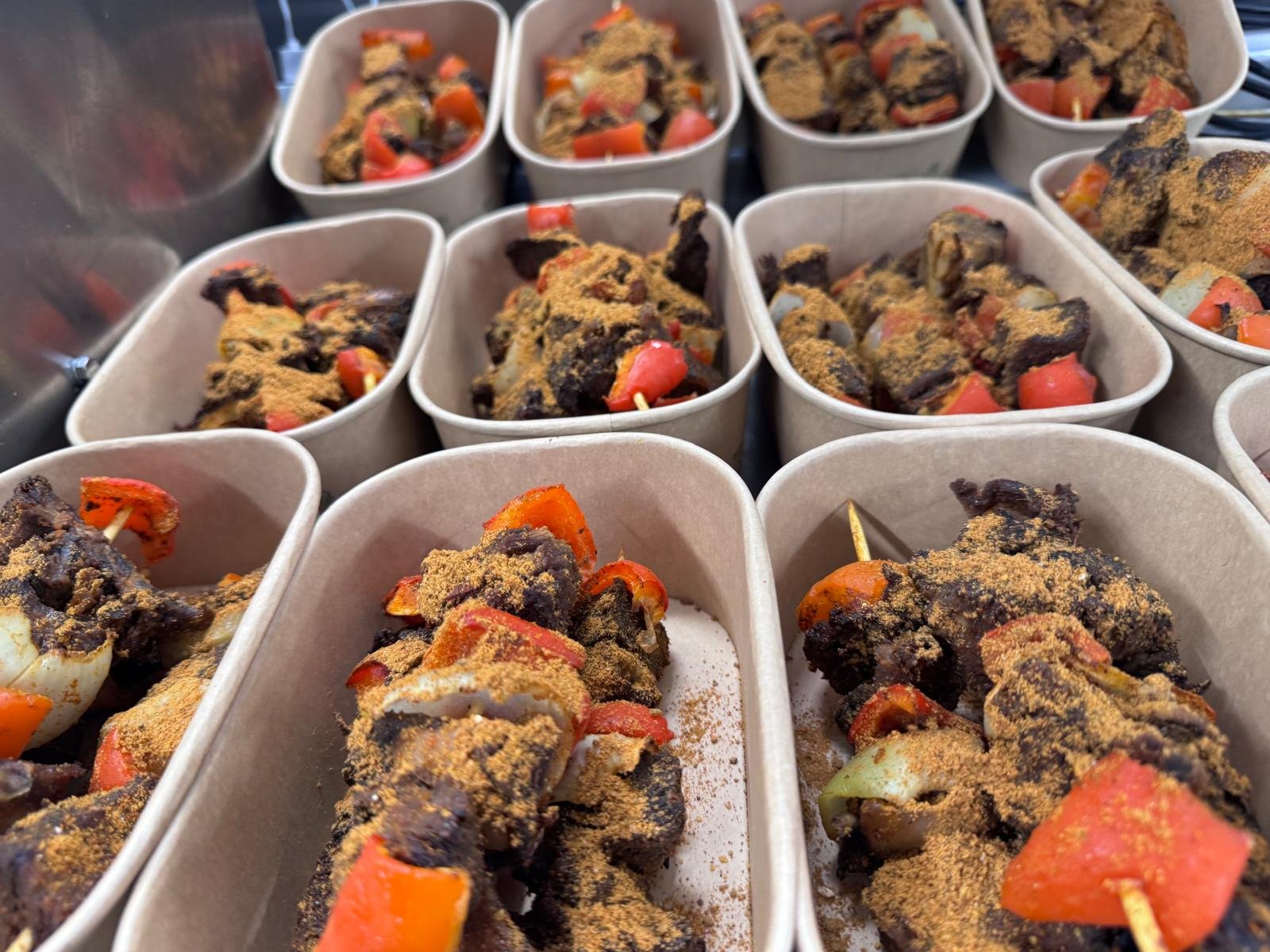 Suya skewers dusted with yaji spice, packed into takeaway trays
